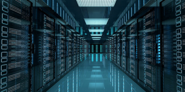 Modern data center with illuminated server racks and reflective floor.
