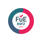 Circular logo with a semi-circular blue and pink segment. In the center is "FüE BSFZ 2025" in dark blue lettering, with a pink tick above the "ü".